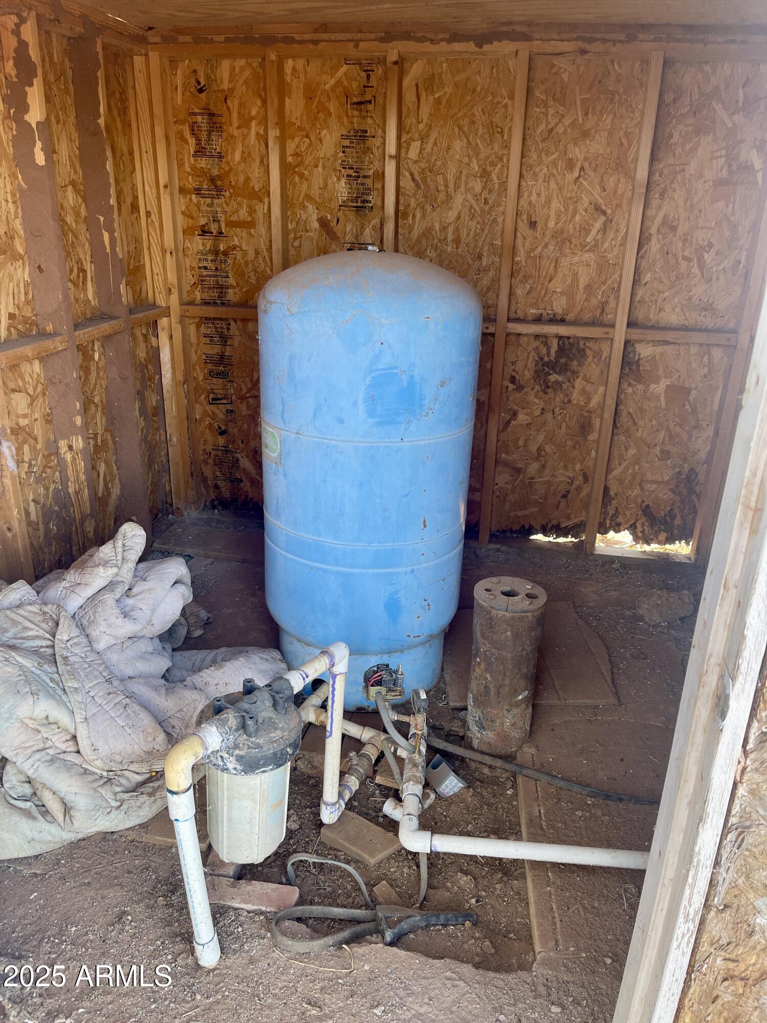 3983 North Plantation Road Douglas, AZ 85607 - Photo 7 of 9 a room with water heater and wooden floor