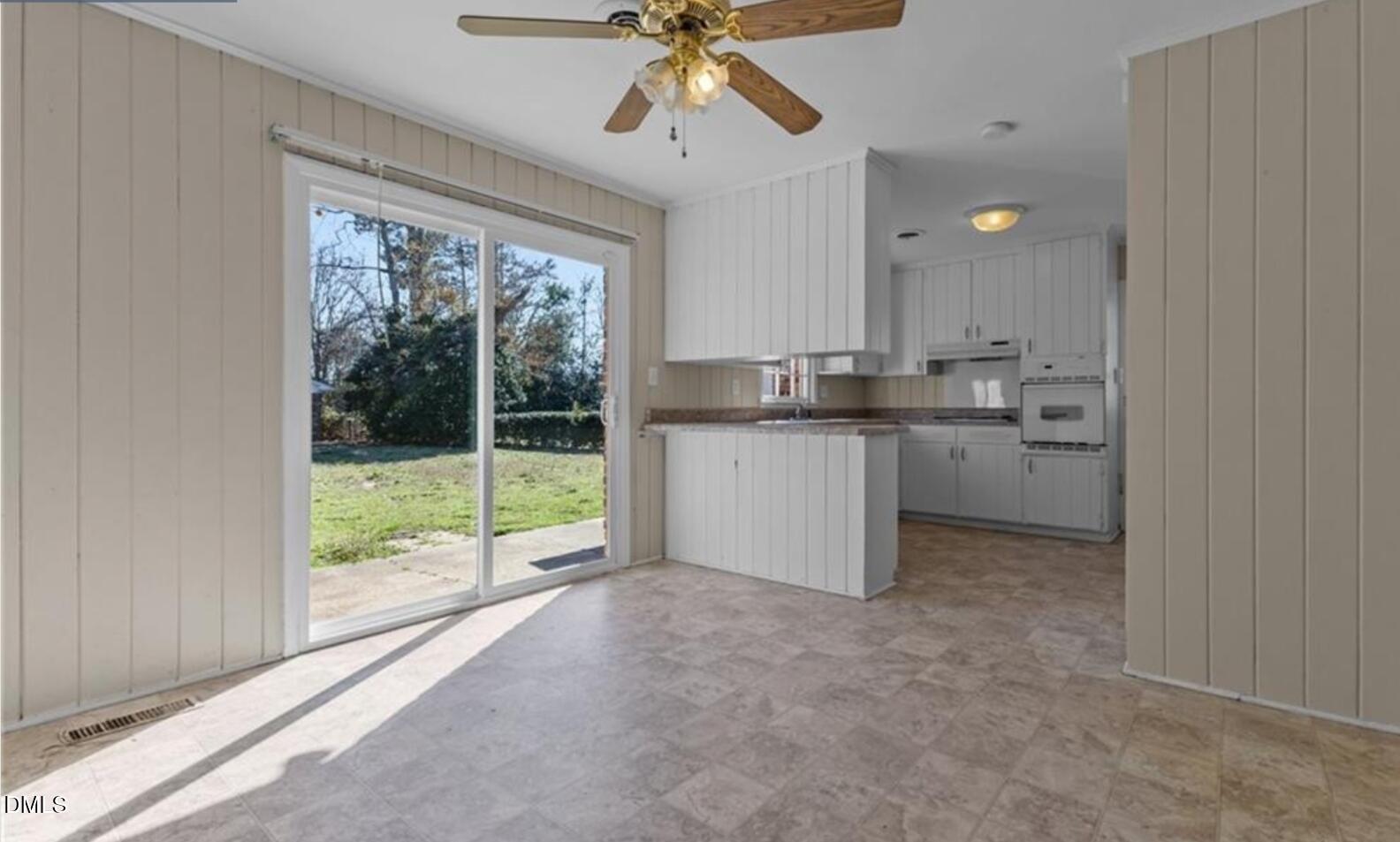 414 York Road Fayetteville, NC 28303 - Photo 8 of 14 a kitchen with kitchen island a large window cabinets a sink and appliances
