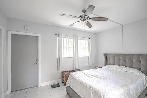 a bedroom with a large bed and a chandelier
