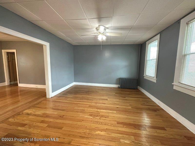 428 Cherry Street Scranton, PA 18505 - Photo 3 of 29 an empty room with wooden floor and windows