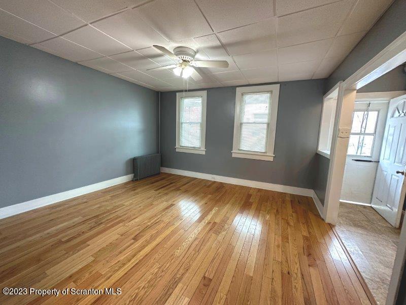 428 Cherry Street Scranton, PA 18505 - Photo 4 of 29 an empty room with wooden floor and windows