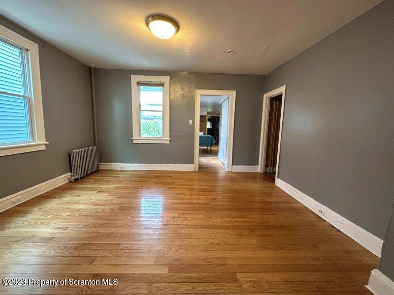 428 Cherry Street Scranton, PA 18505 - Photo 5 of 29 an empty room with wooden floor and windows