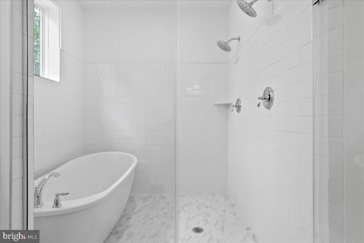8 Grim Road Stephens City, VA 22655 - Photo 20 of 29 a white bath tub sitting next to a white sink and vanity