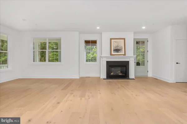a view of an empty room with a window and fireplace