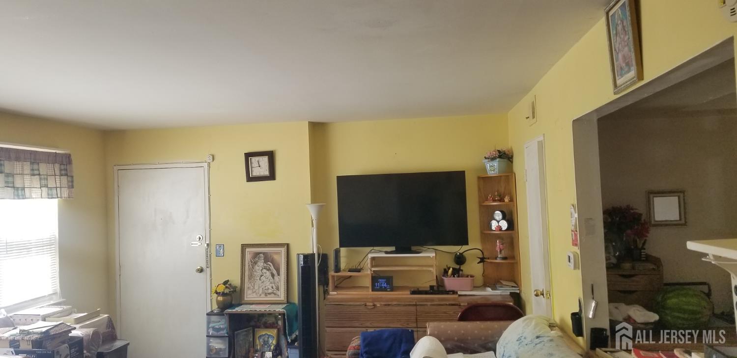 32 Judson Street, Unit 10A Edison, NJ 08837 - Photo 7 of 12 a living room with furniture and a flat screen tv