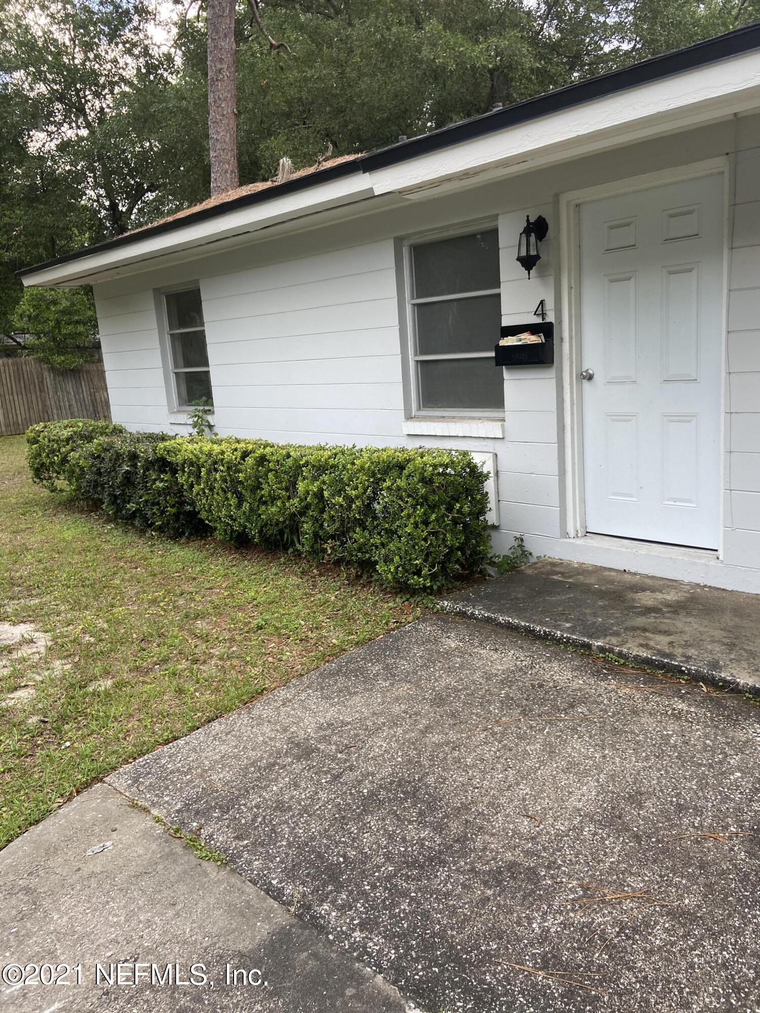 5643 Merrill Road, Unit 4 Jacksonville, FL 32277 - Photo 1 of 9 a front view of a house with garden