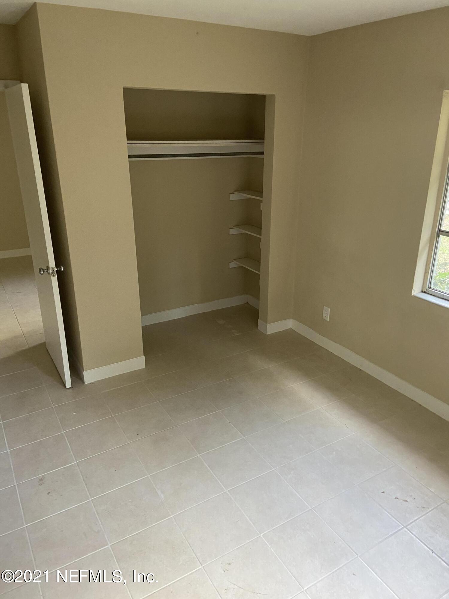 5643 Merrill Road, Unit 4 Jacksonville, FL 32277 - Photo 5 of 9 an empty room with closet