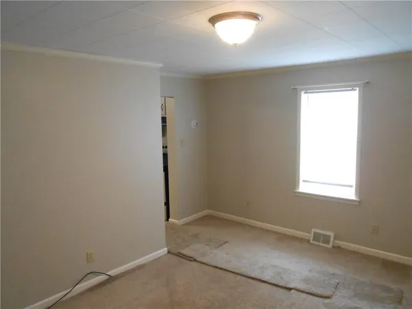 an empty room with a empty space and a window