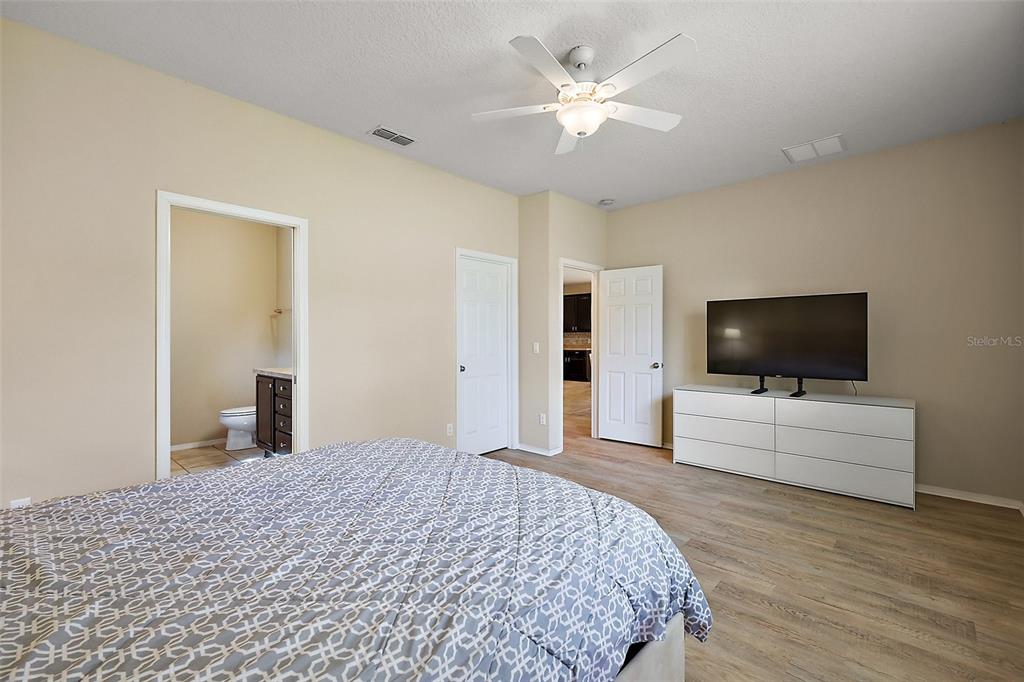 20945 Oldenburg Loop Mount Dora, FL 32757 - Photo 18 of 37 a bedroom with a bed and a flat screen tv