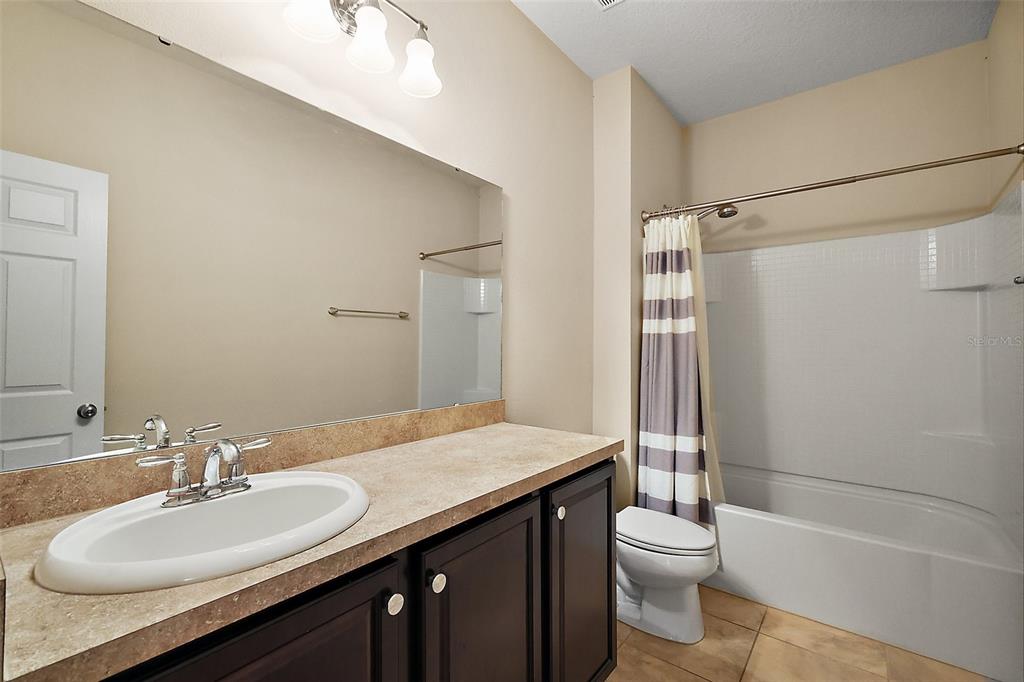 20945 Oldenburg Loop Mount Dora, FL 32757 - Photo 21 of 37 a bathroom with a sink a toilet and shower
