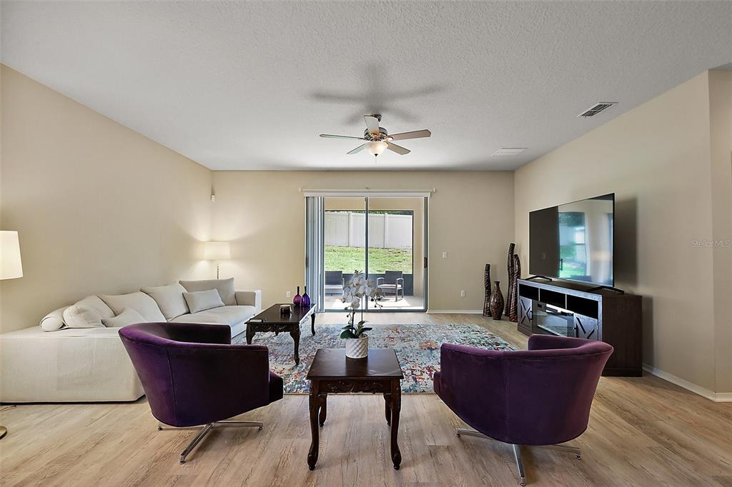 20945 Oldenburg Loop Mount Dora, FL 32757 - Photo 5 of 37 a living room with furniture and a flat screen tv