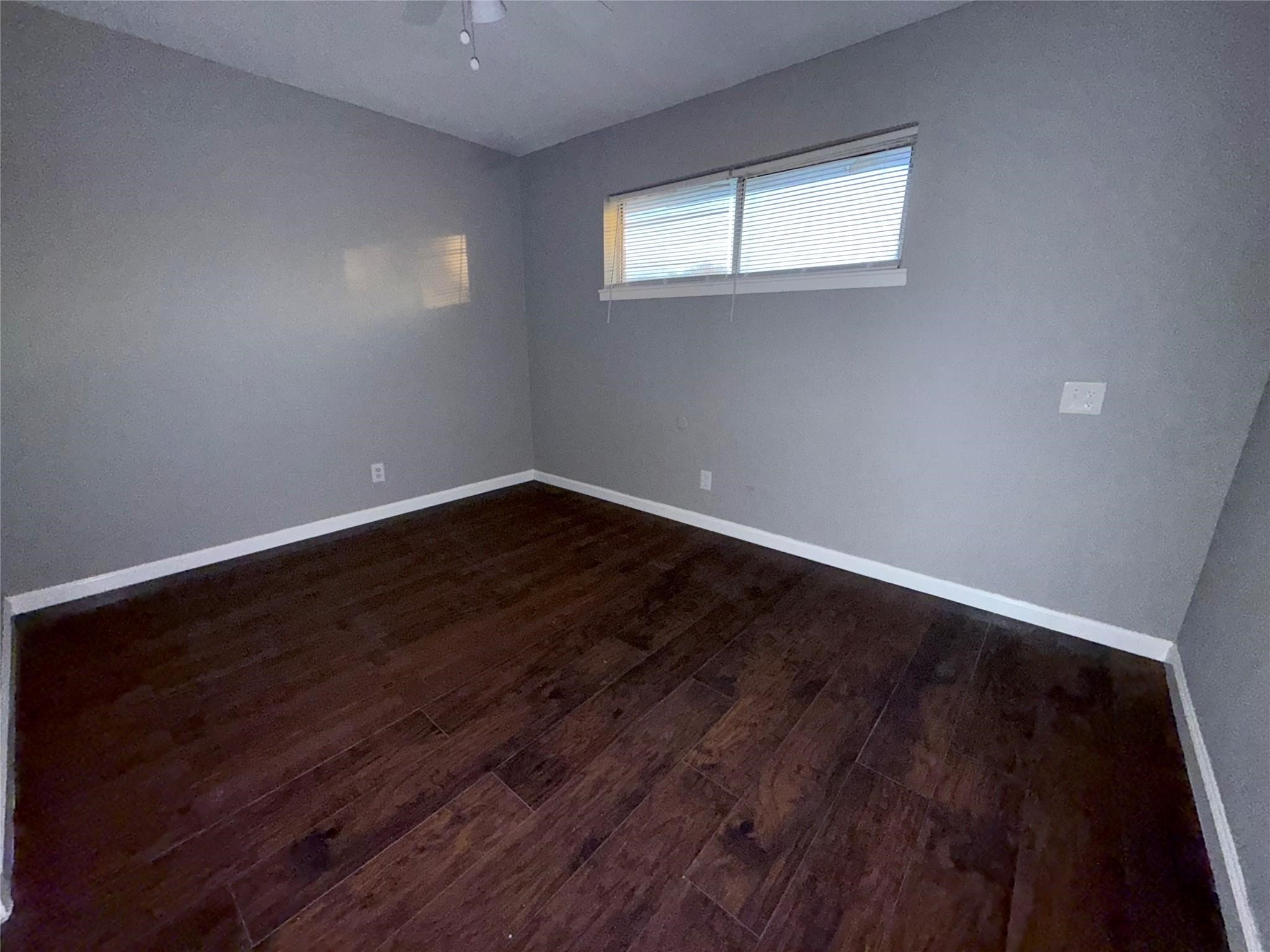5418 Weaver Road, Unit D Houston, TX 77016 - Photo 7 of 10 a view of a room with wooden floor and window