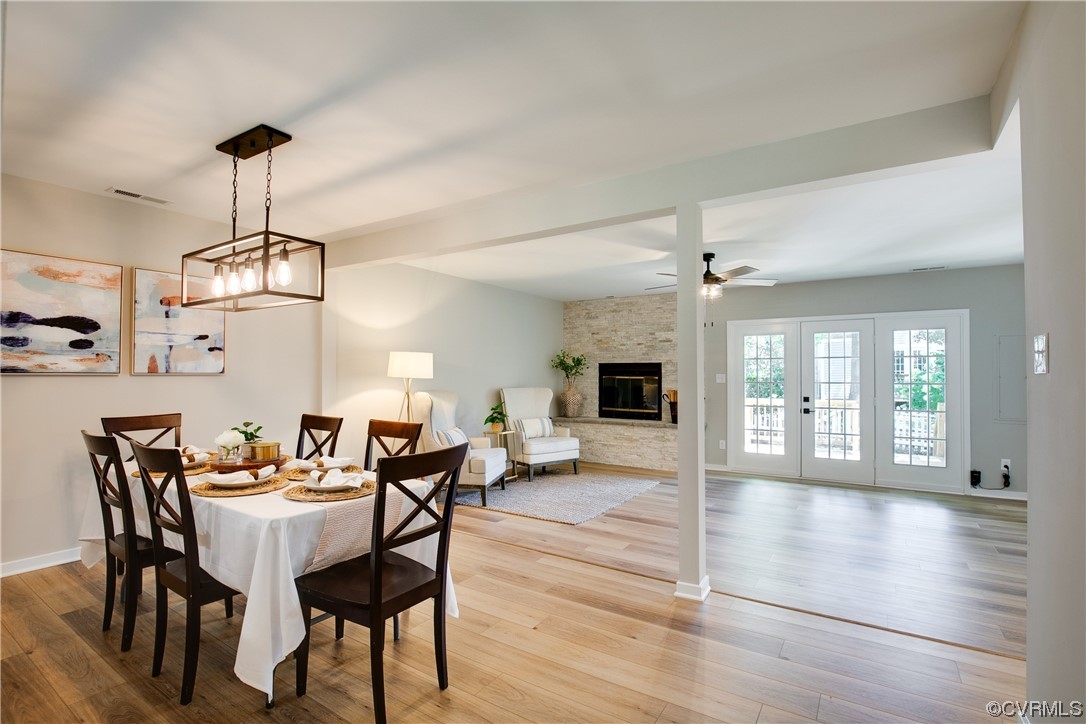 2102 Waters Mill Pointe Richmond, VA 23235 - Photo 13 of 43 a view of a dining room with furniture wooden floor and chandelier