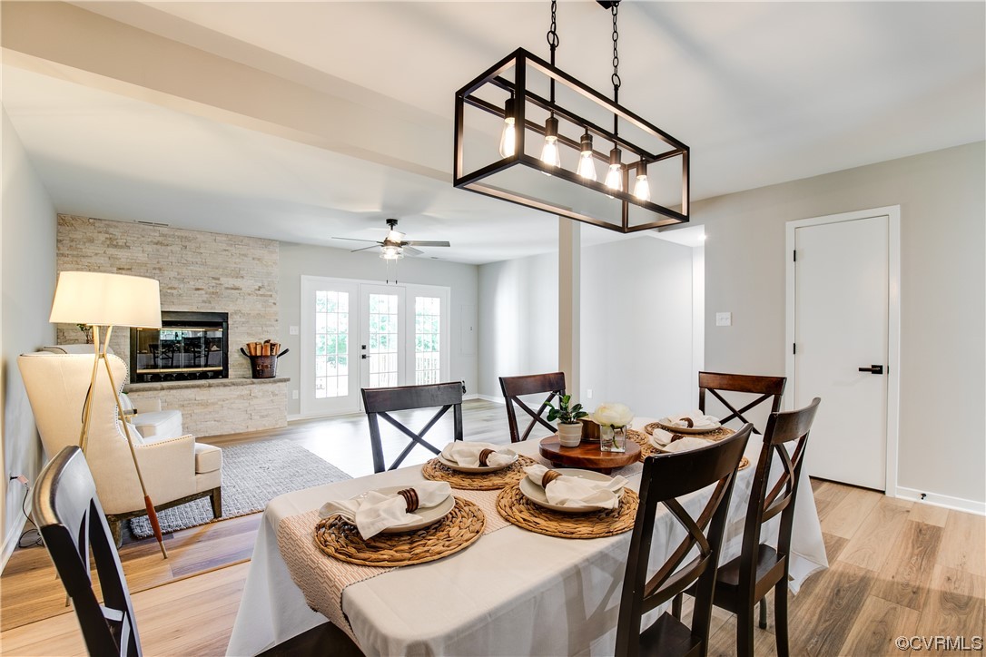2102 Waters Mill Pointe Richmond, VA 23235 - Photo 15 of 43 a view of a dining room with furniture a chandelier and wooden floor