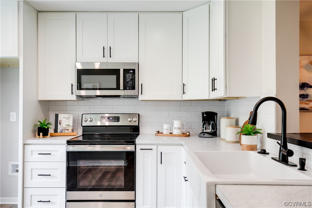 2102 Waters Mill Pointe Richmond, VA 23235 - Photo 6 of 43 a kitchen with cabinets stainless steel appliances a sink and a microwave