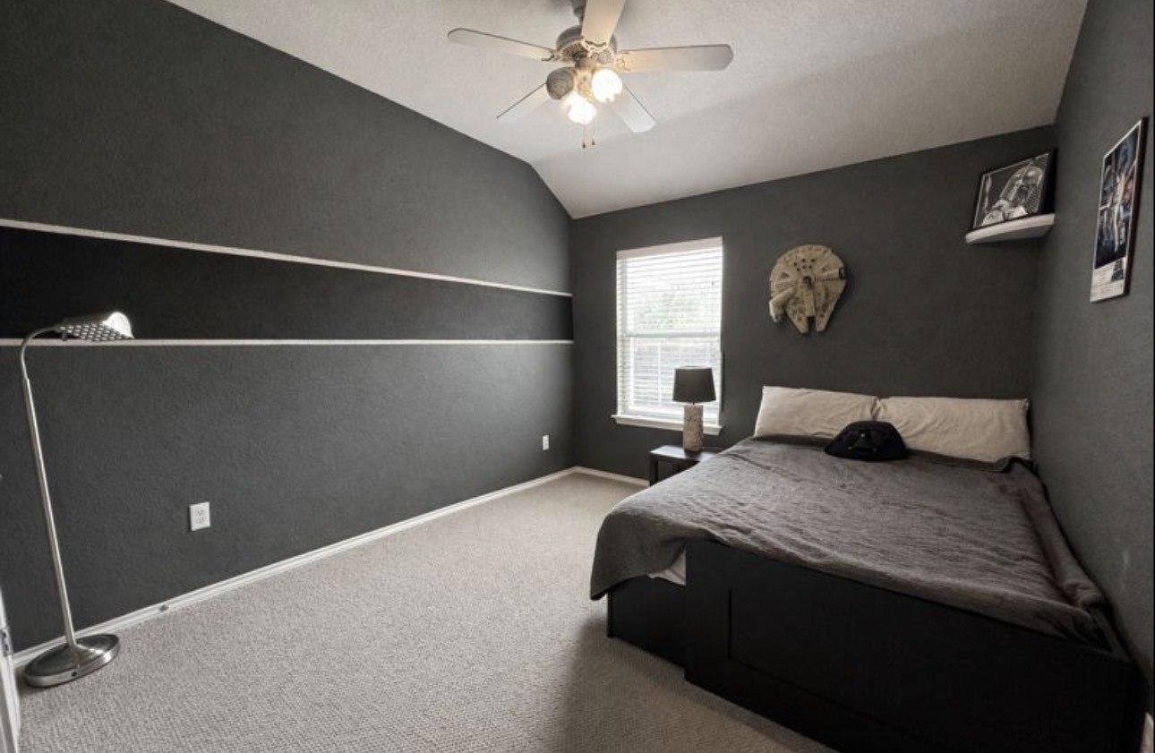 1052 Hot Spring Valley Buda, TX 78610 - Photo 26 of 36 Carpeted bedroom featuring lofted ceiling and ceiling fan