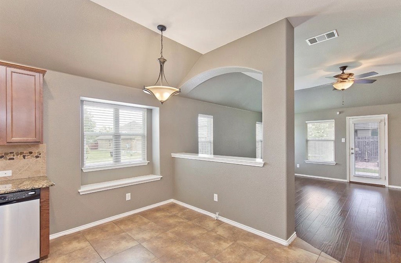 1052 Hot Spring Valley Buda, TX 78610 - Photo 9 of 36 Unfurnished dining area featuring lofted ceiling, ceiling fan, and healthy amount of natural light