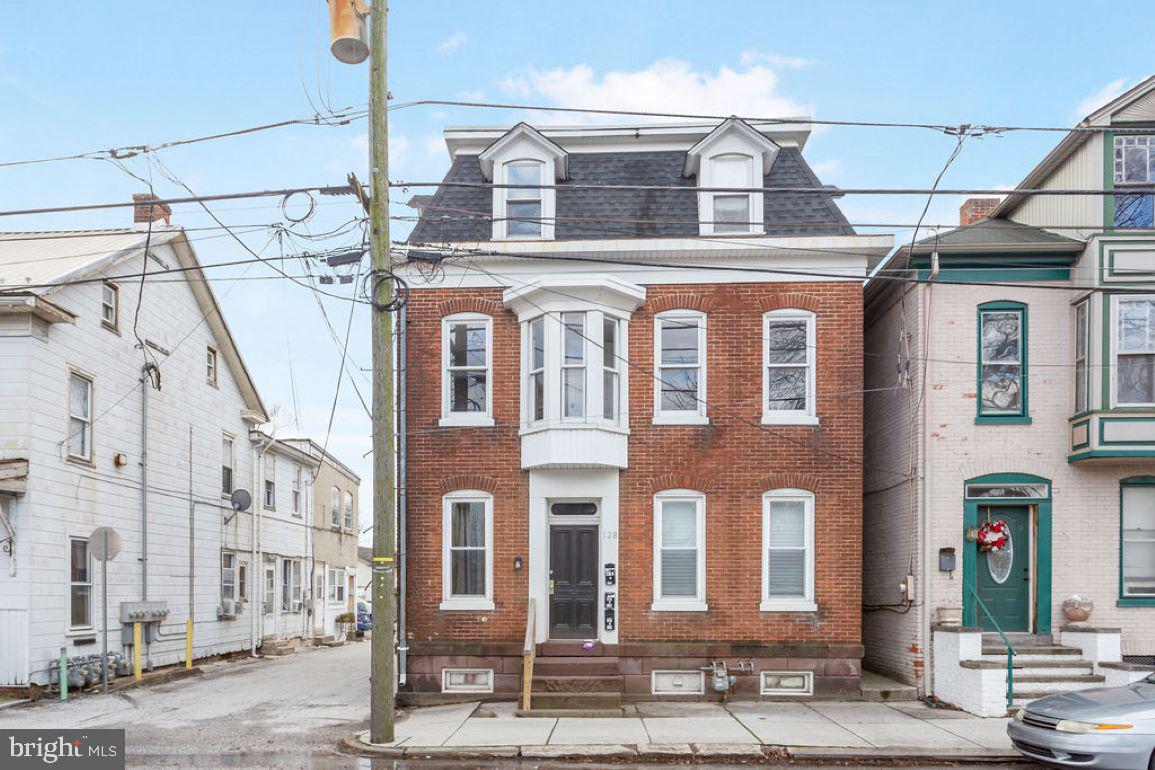 a front view of a building with a street
