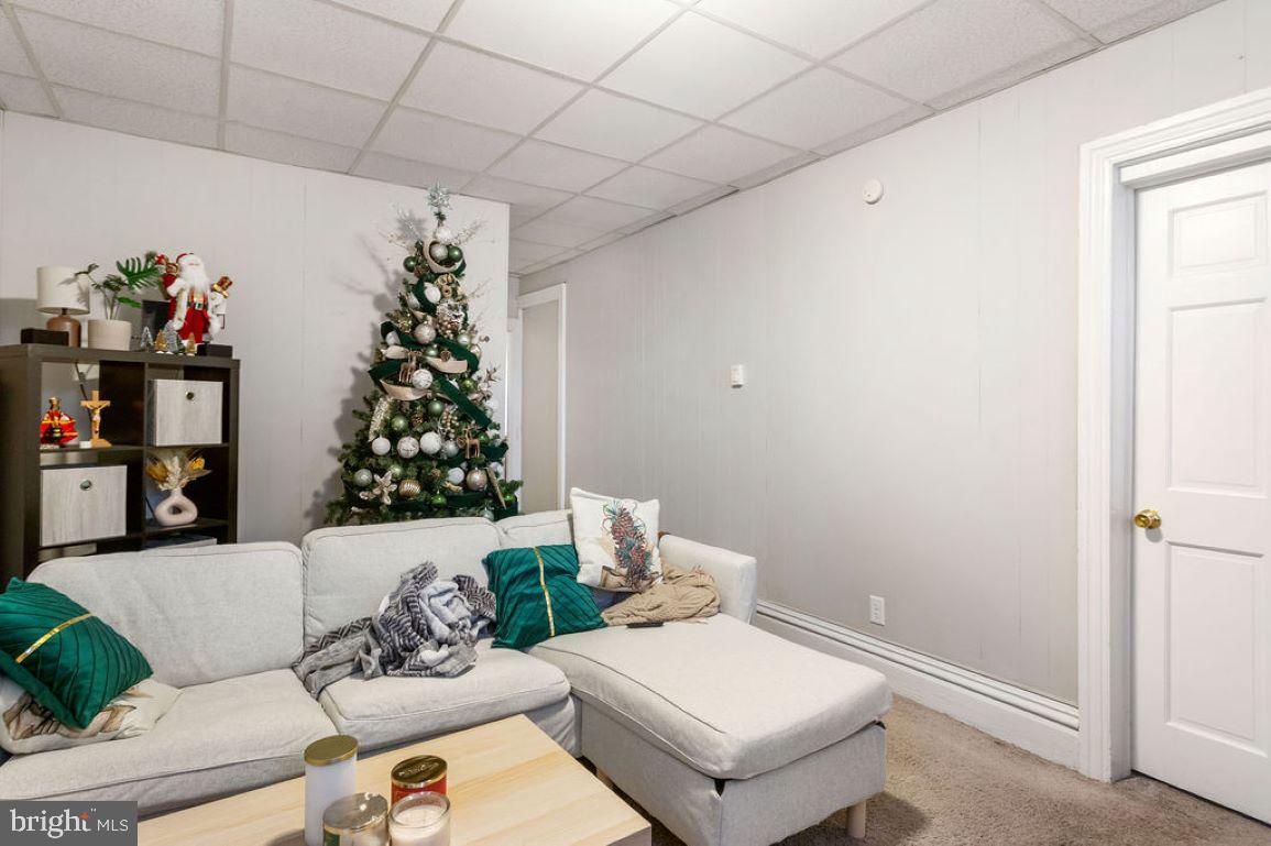 128 High Street Hanover, PA 17331 - Photo 21 of 36 a living room with furniture and a potted plant
