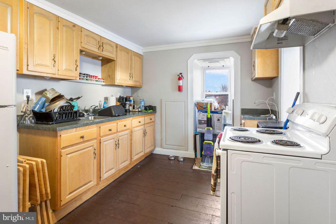 128 High Street Hanover, PA 17331 - Photo 30 of 36 a kitchen with stainless steel appliances granite countertop a stove a sink and a refrigerator