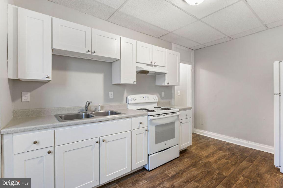 128 High Street Hanover, PA 17331 - Photo 4 of 36 a kitchen with granite countertop white cabinets and white appliances