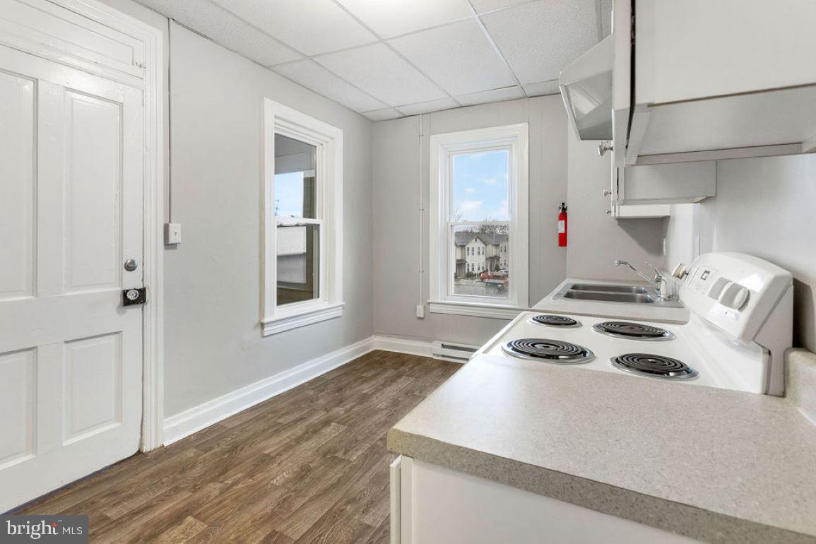 128 High Street Hanover, PA 17331 - Photo 5 of 36 a kitchen that has a stove and a wooden floor