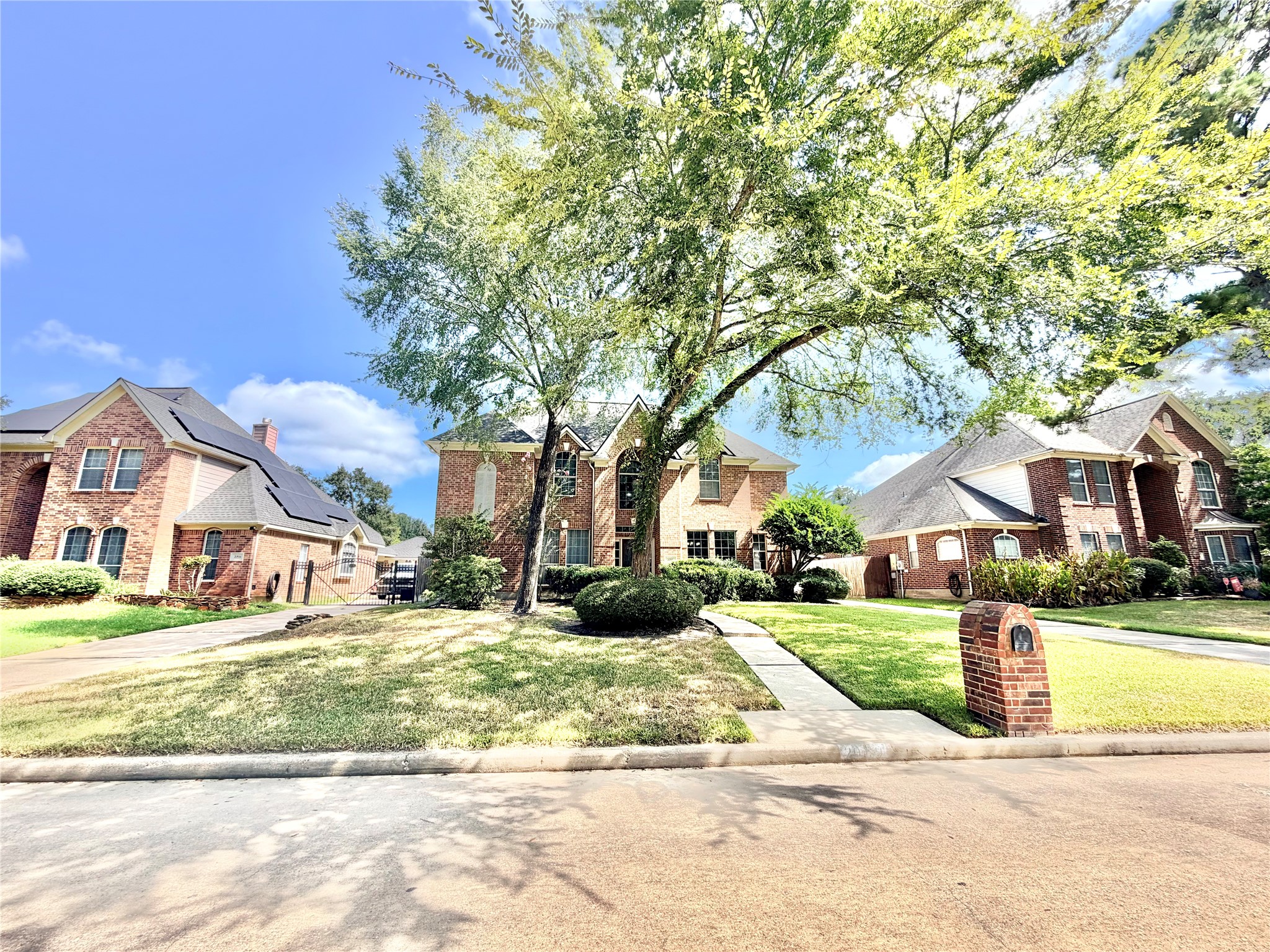 20110 Forest Drive Spring, TX 77388 - Photo 2 of 43 Charming brick home with a classic design, nestled under mature trees and featuring a well-maintained front lawn.