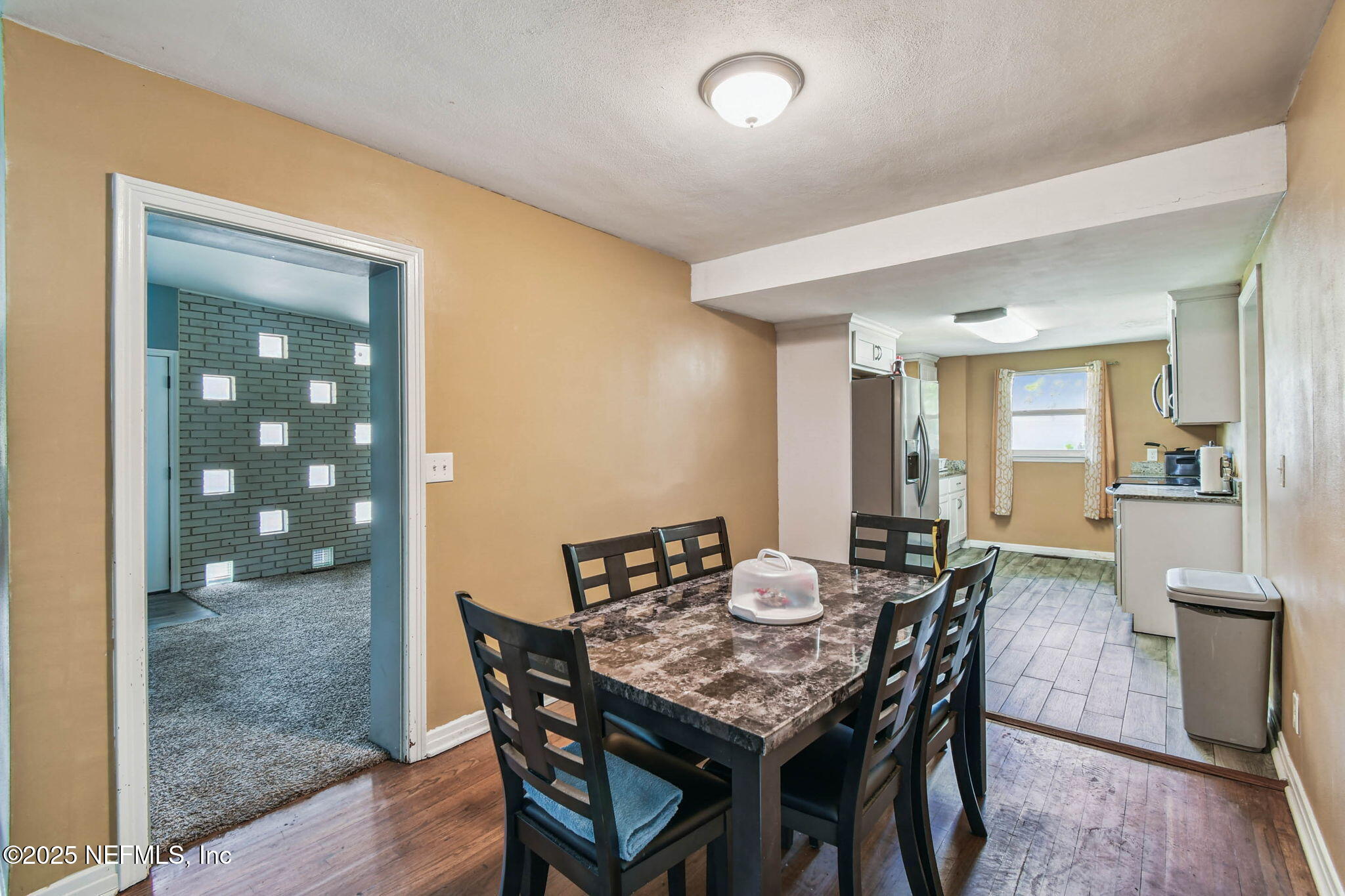 623 Mandalay Road Jacksonville, FL 32216 - Photo 11 of 36 a view of a dining room with furniture and wooden floor