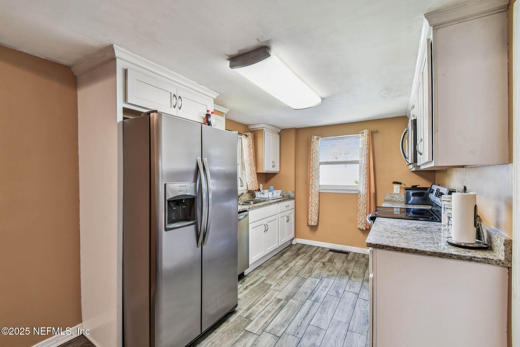 623 Mandalay Road Jacksonville, FL 32216 - Photo 12 of 36 a kitchen with granite countertop stainless steel appliances a refrigerator a stove top oven a sink and dishwasher