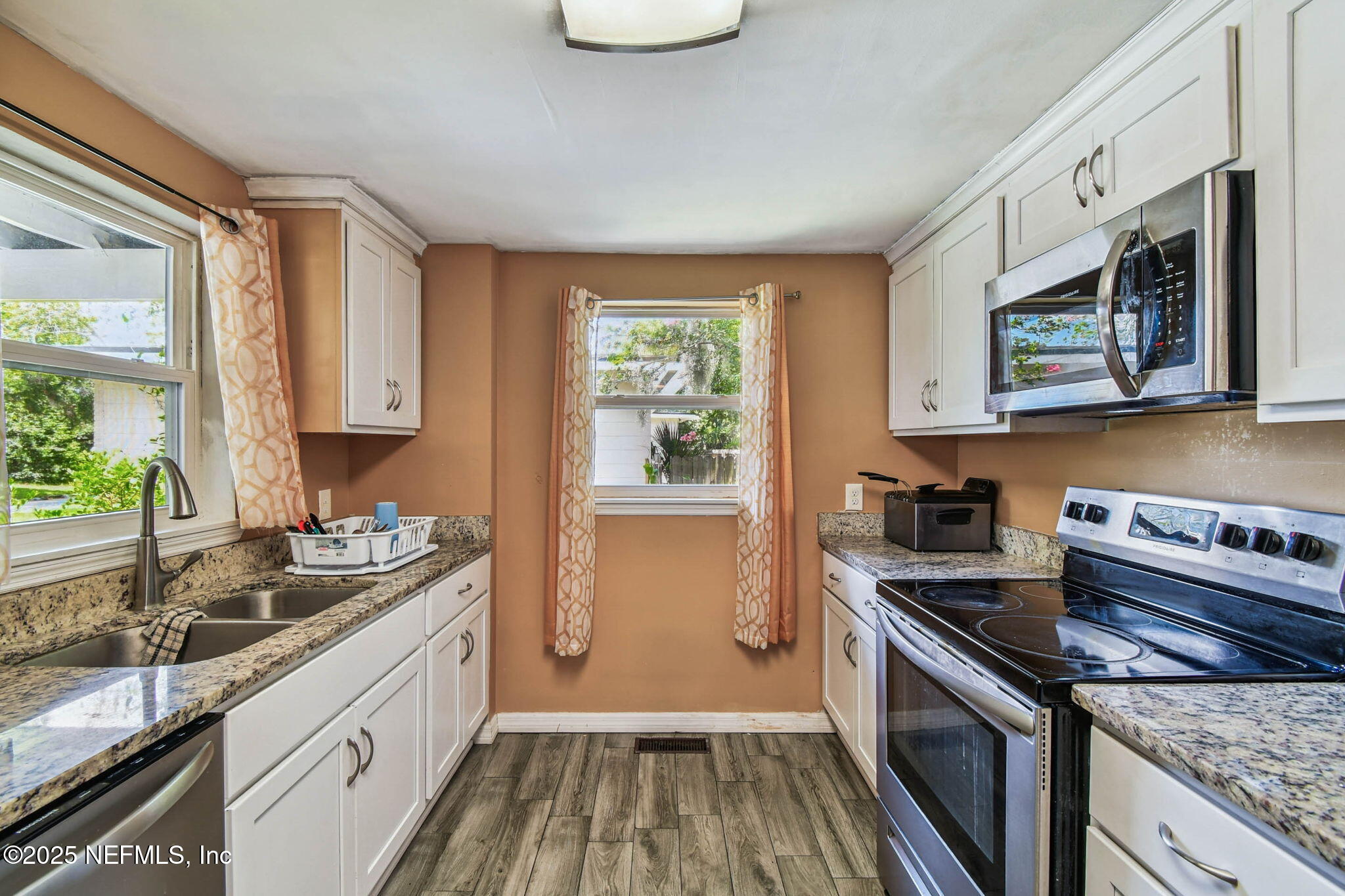 623 Mandalay Road Jacksonville, FL 32216 - Photo 14 of 36 a kitchen with stainless steel appliances granite countertop a sink stove and cabinets