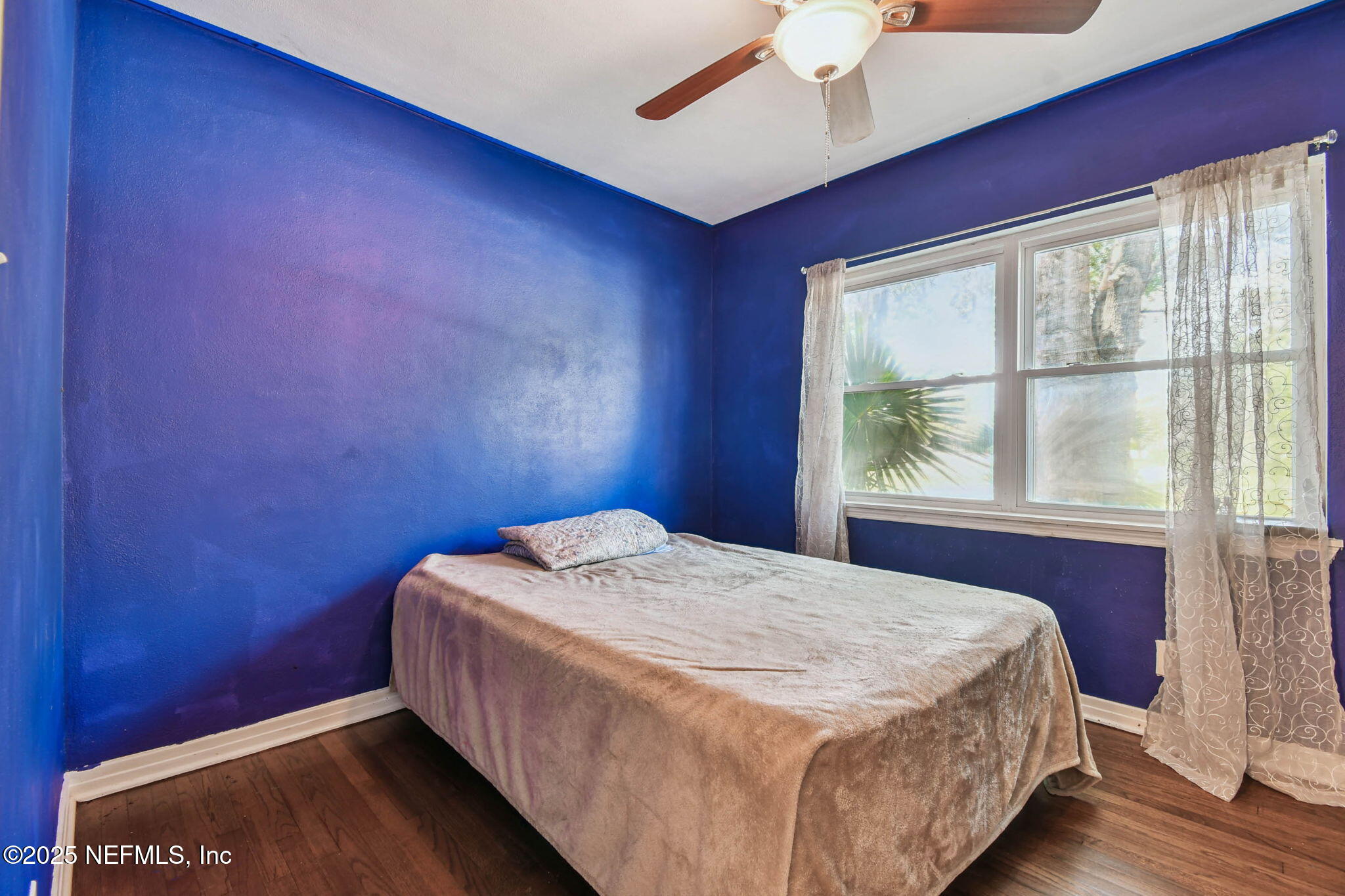 623 Mandalay Road Jacksonville, FL 32216 - Photo 19 of 36 a bed sitting in a bedroom next to a window