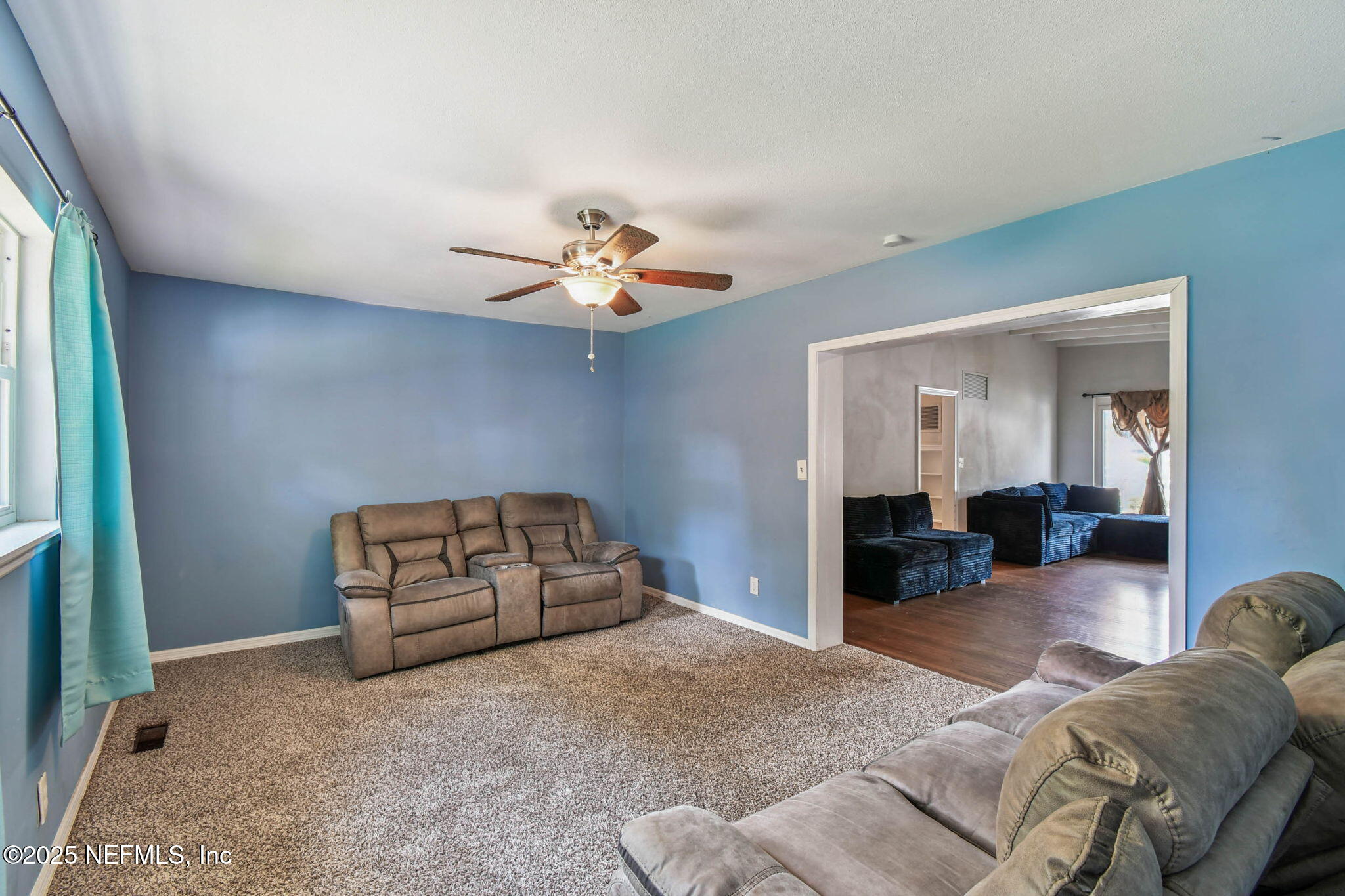623 Mandalay Road Jacksonville, FL 32216 - Photo 7 of 36 a living room with furniture and a chandelier
