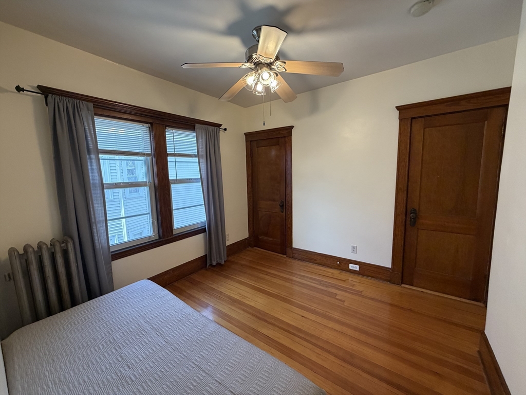 46 Walker Street, Unit 2 Somerville, MA 02144 - Photo 13 of 18 a bedroom with a bed and a large window