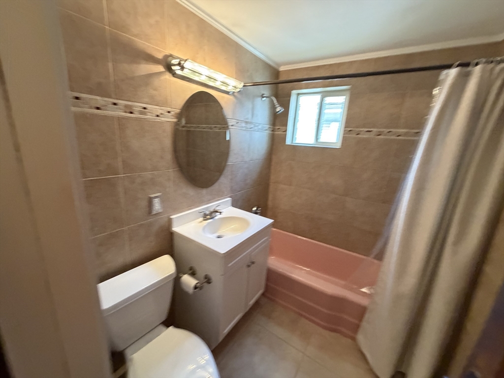 46 Walker Street, Unit 2 Somerville, MA 02144 - Photo 16 of 18 a bathroom with a toilet a sink and a mirror