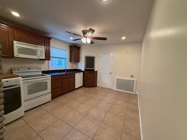 a kitchen with cabinets and stainless steel appliances