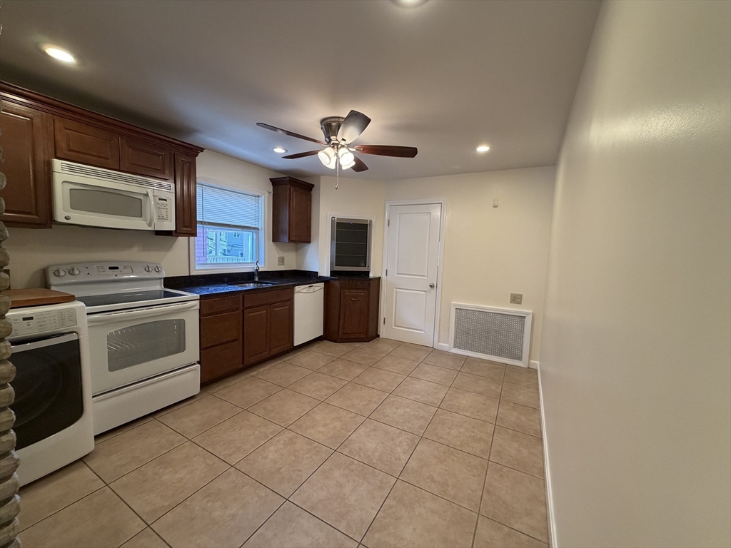 46 Walker Street, Unit 2 Somerville, MA 02144 - Photo 4 of 18 a kitchen with cabinets and stainless steel appliances