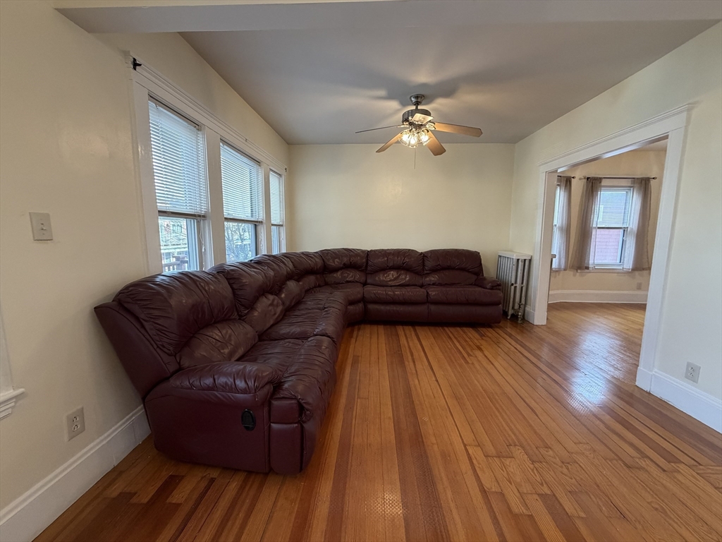 46 Walker Street, Unit 2 Somerville, MA 02144 - Photo 5 of 18 a living room with a bed furniture and a window