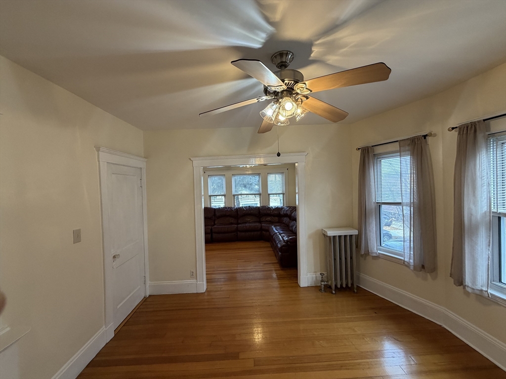 46 Walker Street, Unit 2 Somerville, MA 02144 - Photo 9 of 18 a view of empty room with wooden floor and fan