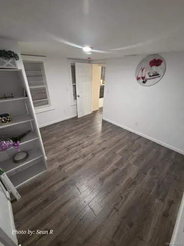 a view of a livingroom with wooden floor and white walls