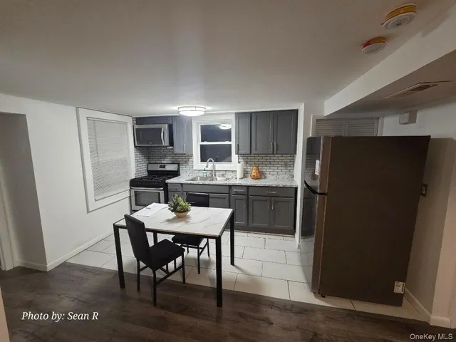 a kitchen with a table and chairs in it
