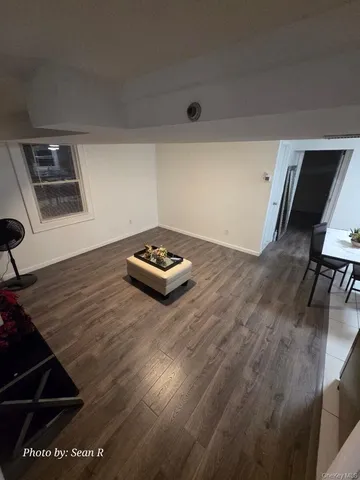 a view of a workspace with wooden floor