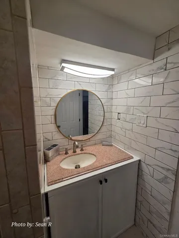 a bathroom with a sink and a mirror