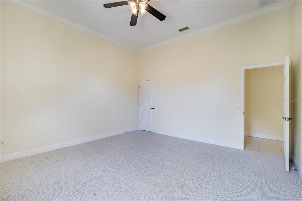 2718 Knightsbridge Road Clermont, FL 34711 - Photo 17 of 72 an empty room with a chandelier fan