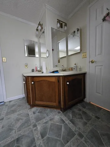 a spacious bathroom with a double vanity sink and mirror
