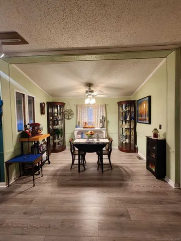 a living room with furniture and a dining table
