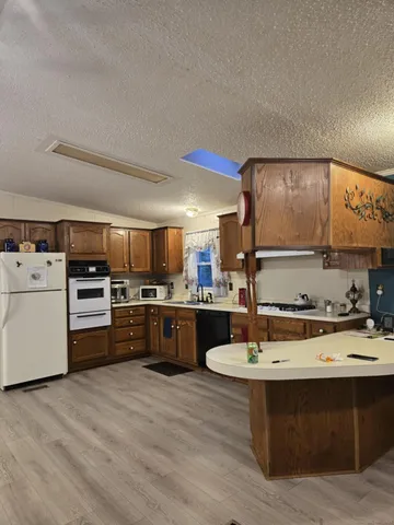 a kitchen with a stove a sink and a refrigerator