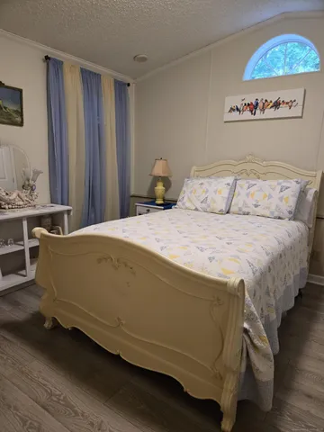 a bedroom with a bed and a window