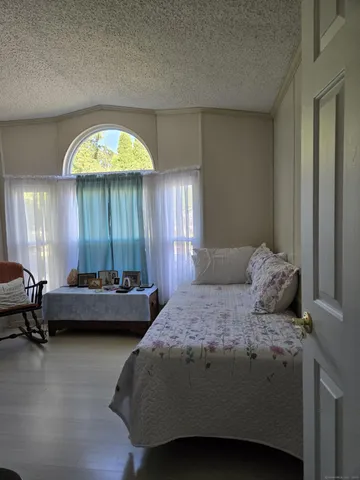 a bedroom with a bed and a lounge chair