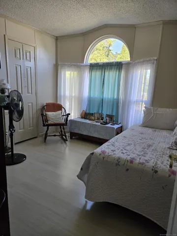 a spacious bedroom with two beds and a chandelier