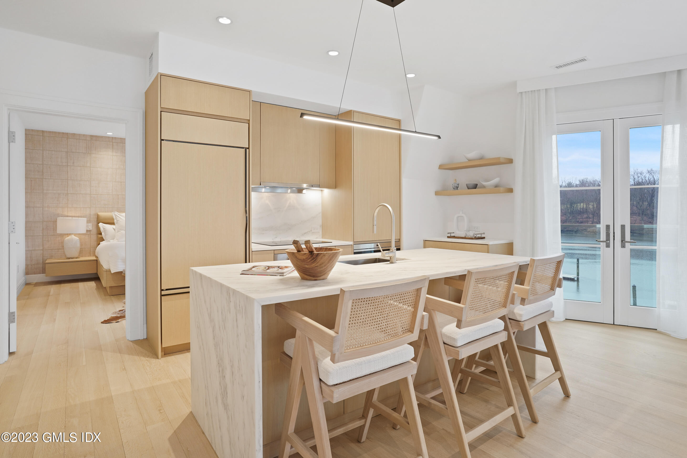 89 River Road, Unit 204 Cos Cob, CT 06807 - Photo 4 of 25 a dining area with a table chairs and a refrigerator